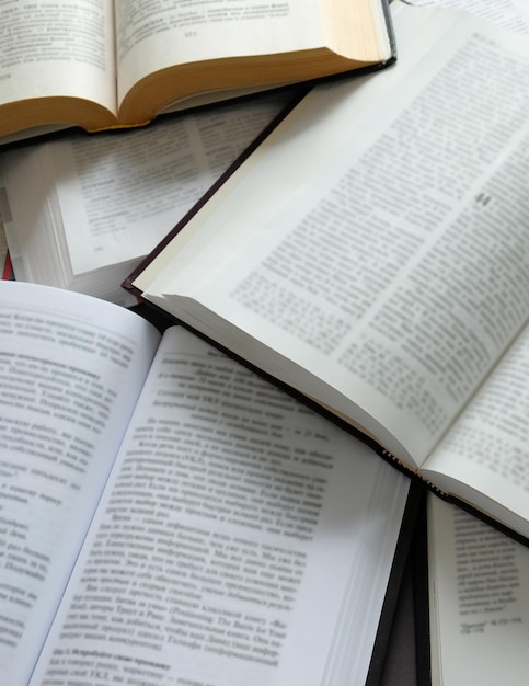 There are a lot of open books on the table