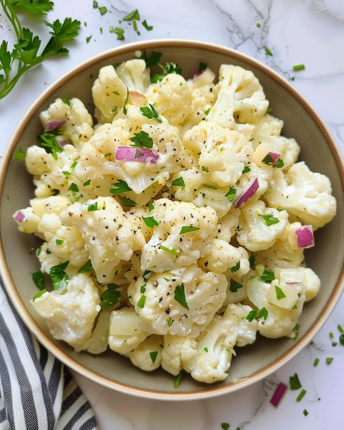 Photo there is a bowl of cauliflower salad with herbs on the side generative ai