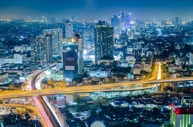 There is an expressway running through Beautiful skyscrapers at night in a modern and civilized city