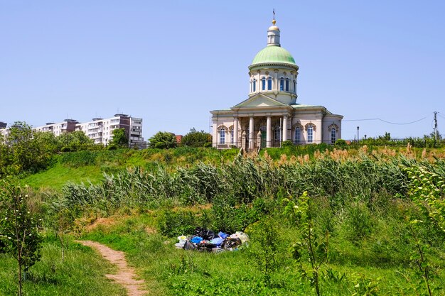 There is a pile of household waste and various household garbage thrown out by unconscious people on the green grass in nature. Rostov-on-Don, Russia, June 21, 2021