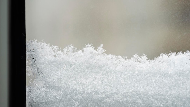 There was a lot of snow outside the window during the winter day.