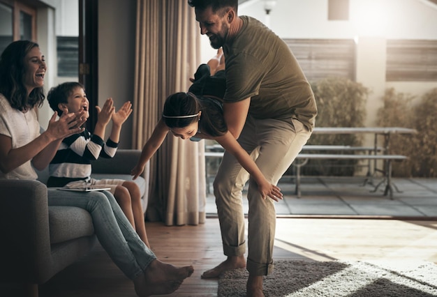 Theres always time for family Shot of a happy young family spending quality time together at at home