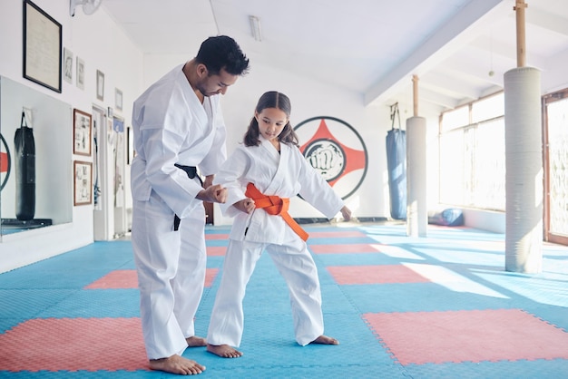 Theres no cant in our karate class. Shot of a young man and cute little girl practicing karate in a studio.