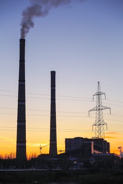 Thermal power plant and sunset fiery sky.