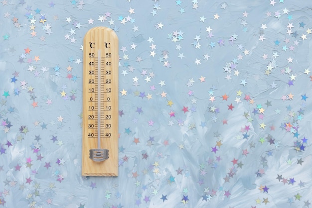 Thermometer shows low plus temperature and Christmas decoration Winter holiday weather