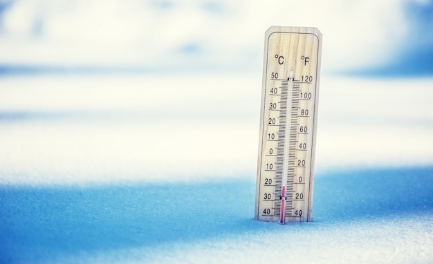 Thermometer on snow shows low temperatures Low temperatures in degrees Celsius and fahrenheit