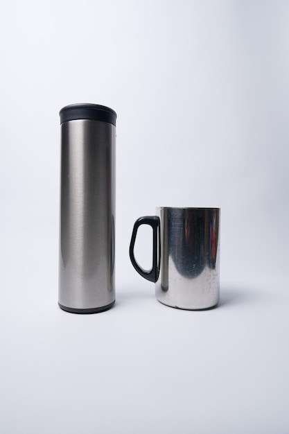 Thermos bottle and stainless steel glass isolated on a white background