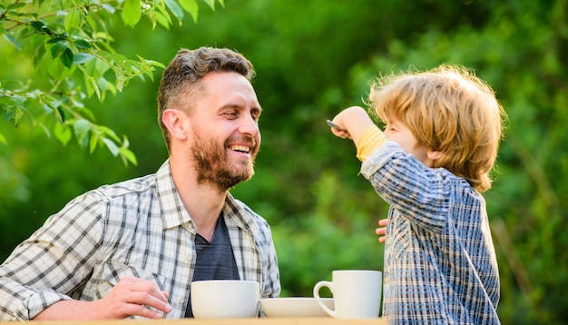 they love eating together. Weekend breakfast. healthy food. Family day bonding. small boy child with dad. organic and natural food. father and son eat outdoor. My family.