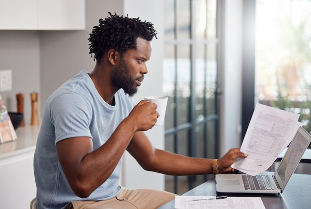 They watch cause the moves I make out their budget Shot of a man going through some paperwork and looking worried at home while having coffee