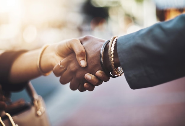 Theyve settled on something Closeup shot of two businesswomen shaking hands in the city