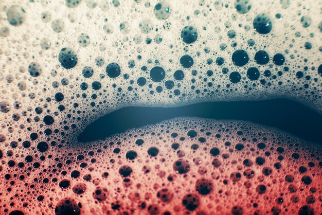 Thick bubbling soap suds on the surface of the water trendy colors gradient Macro Texture of soap bubbles foam