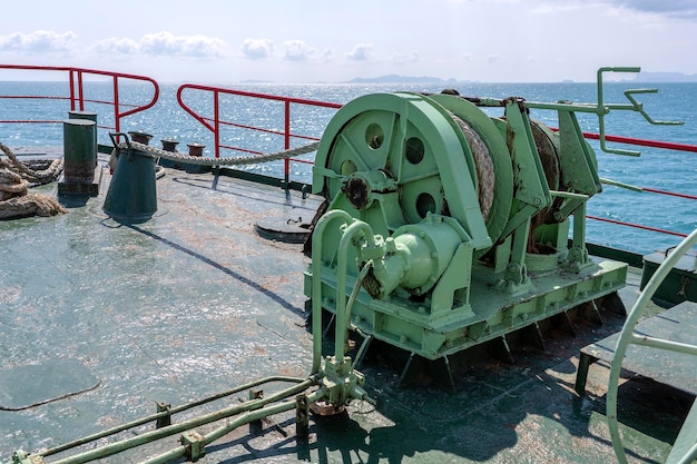 A thick rope is wrapped around a drum on deck of a ferry boat Thailand Closeup