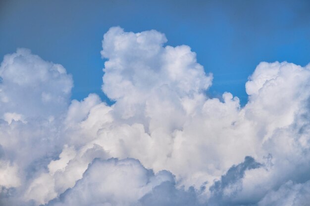 Thick white clouds in bright blue sky Minimalistic background for ad text or desktop screensaver