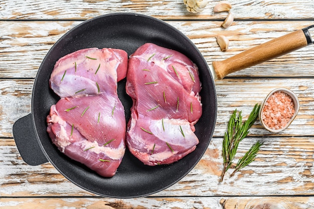 Thigh of farm Turkey in the pan before cooking