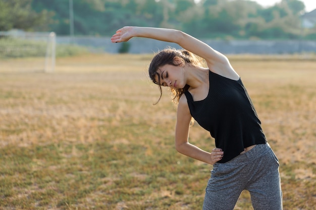 A thin athletic girl takes a break between classes