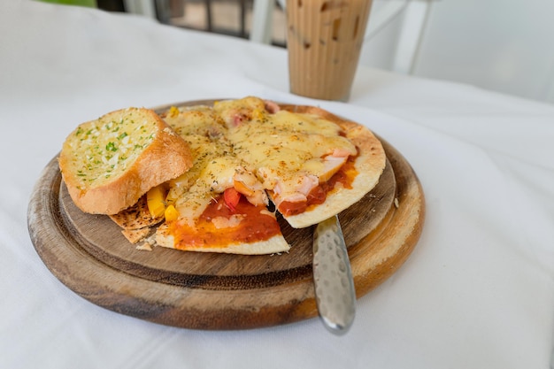 Thin crispy pizza cheese with salmon ham bacon on wooden tray