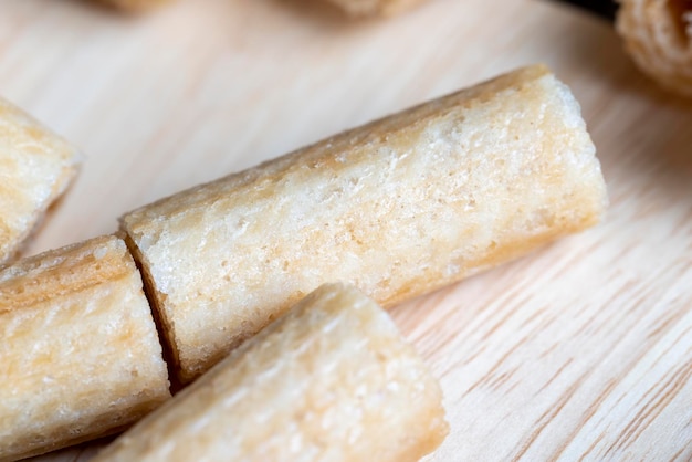 Thin crispy waffles lie on a black table sweet food for desserts