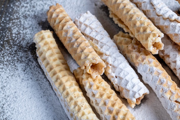 Thin crispy waffles lie on a black table