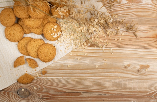 Thin oatmeal cookies mockup. Healthy cereal oat crackers with copy space, anzac biscuit cookie with oat flakes on rustic table background