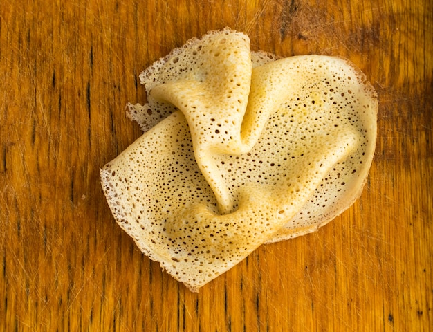 Thin Pancakes on a Wooden Background Top View