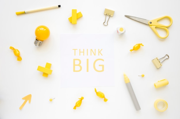 Think big words surrounded by various electric bulb, candies and stationeries