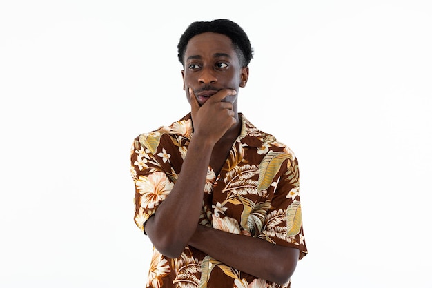 Thinking african american man isolated standing on white background in studio wearing casual