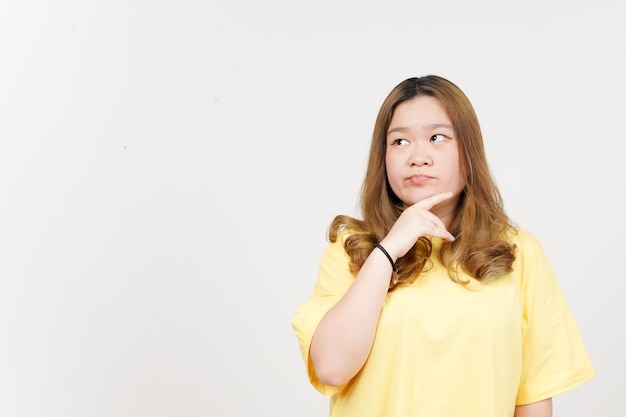 Thinking gesture of Beautiful Asian Woman wearing yellow TShirt Isolated On White Background