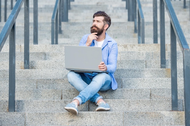 Thinking guy has online video communication outdoor guy has online video communication