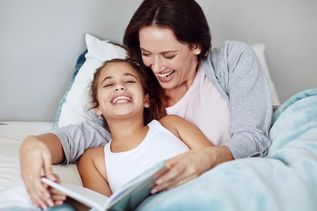 This is the best story Cropped shot of a mother and daughter reading a bedtime story together