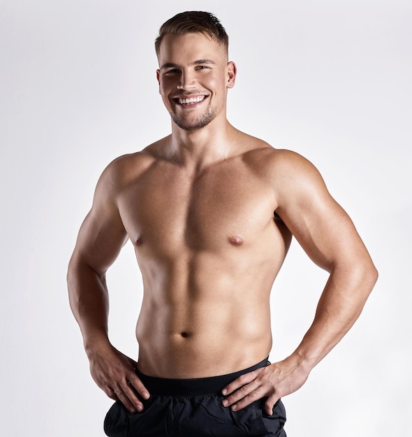 This is the body that dedication gets you Shot of a muscular young man posing against a white background