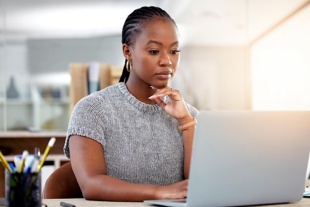 This is not a great email to receive on a Friday. Shot of a young businesswoman working on her laptop.