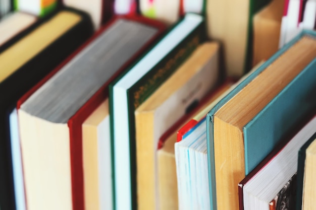 This is a lot of books standing together in several rows Solid background of books in closeup