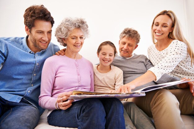 This is my favorite picture of us Shot of a happy multi generation family looking through a photo album together