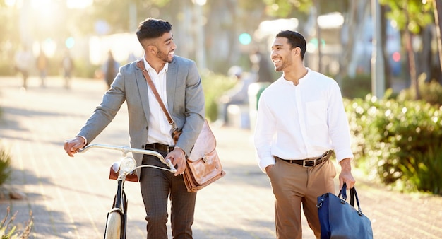 This is our time to catch up Shot of two young businessmen walking through the city together during their afternoon commute from the office