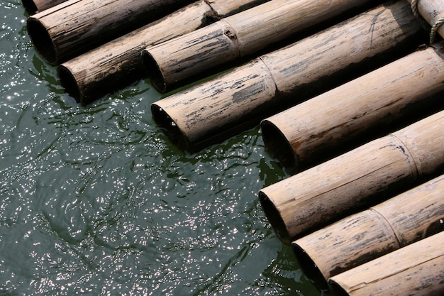 This picture is a wooden raft by the water.