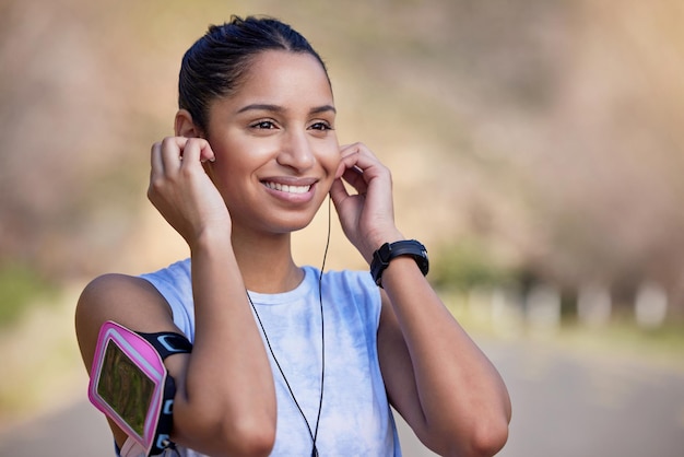 This track always puts me in the mood Cropped shot of an attractive young female athlete listening to music while out for a run