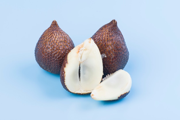 Thorny palm fruits or salak, Tropical fruit on blue background