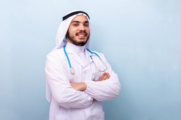 Thoughtful arabian man looking at camera over light blue background