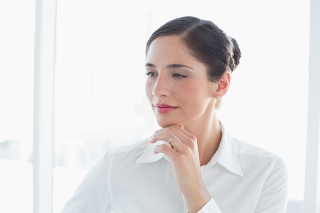 Thoughtful business woman looking away