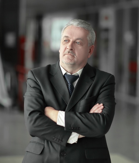 Thoughtful businessman on background of officephoto with copy space