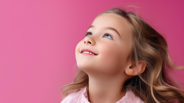 Thoughtful child on pink background looking away