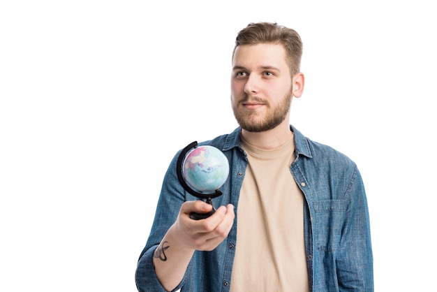 Thoughtful guy holding little globe in