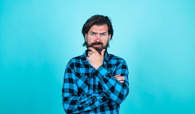 Thoughtful guy mature man has moustache bearded man in checkered shirt brutal guy with emotional face casual male fashion look serious handsome hipster barbershop