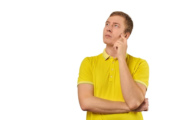 Thoughtful guy in yellow Tshirt looking to left white background philosophical reflection