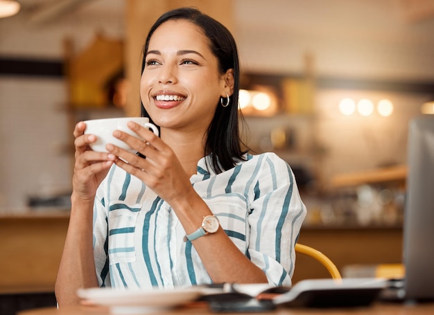 Thoughtful relaxed and satisfied woman drinking coffee thinking and enjoying breakfast break in a cafe Smile lady joyful and having positive ideas while sitting with a warm tea or beverage