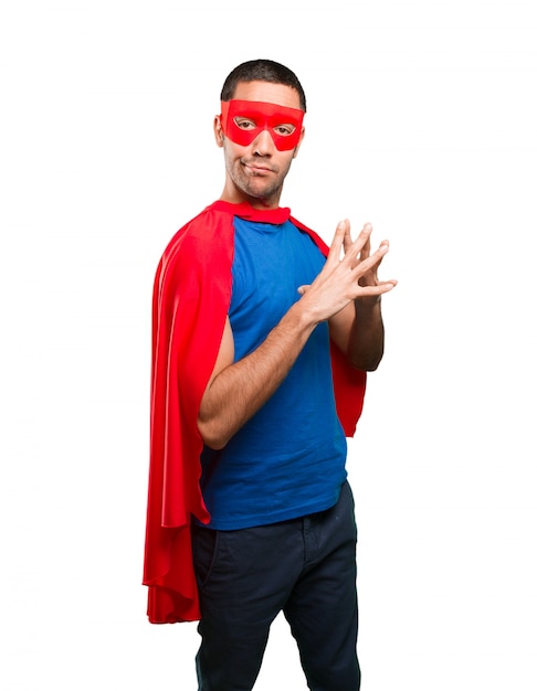 Thoughtful superhero with concentration gesture