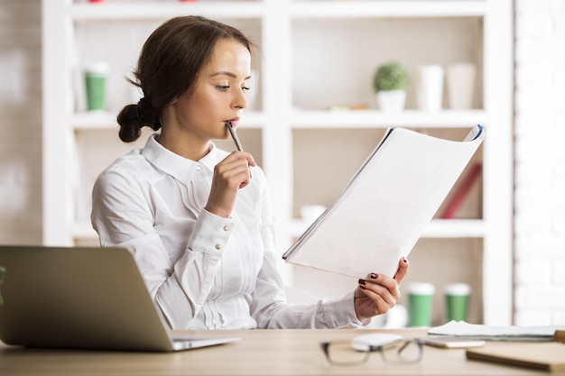 Thoughtful woman doing paperwork