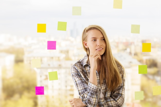 Thoughtful woman next to stickers