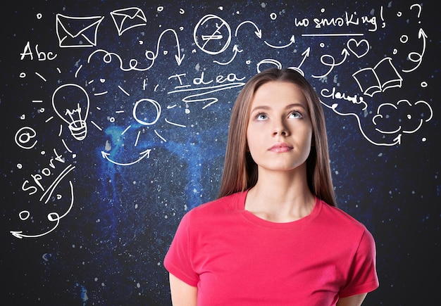 Thoughtful young woman on blackboard background