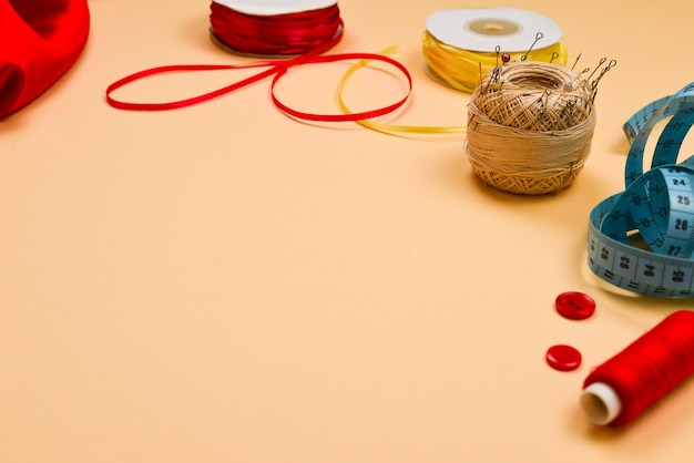 Threads buttons red fabric measuring tape Copy space